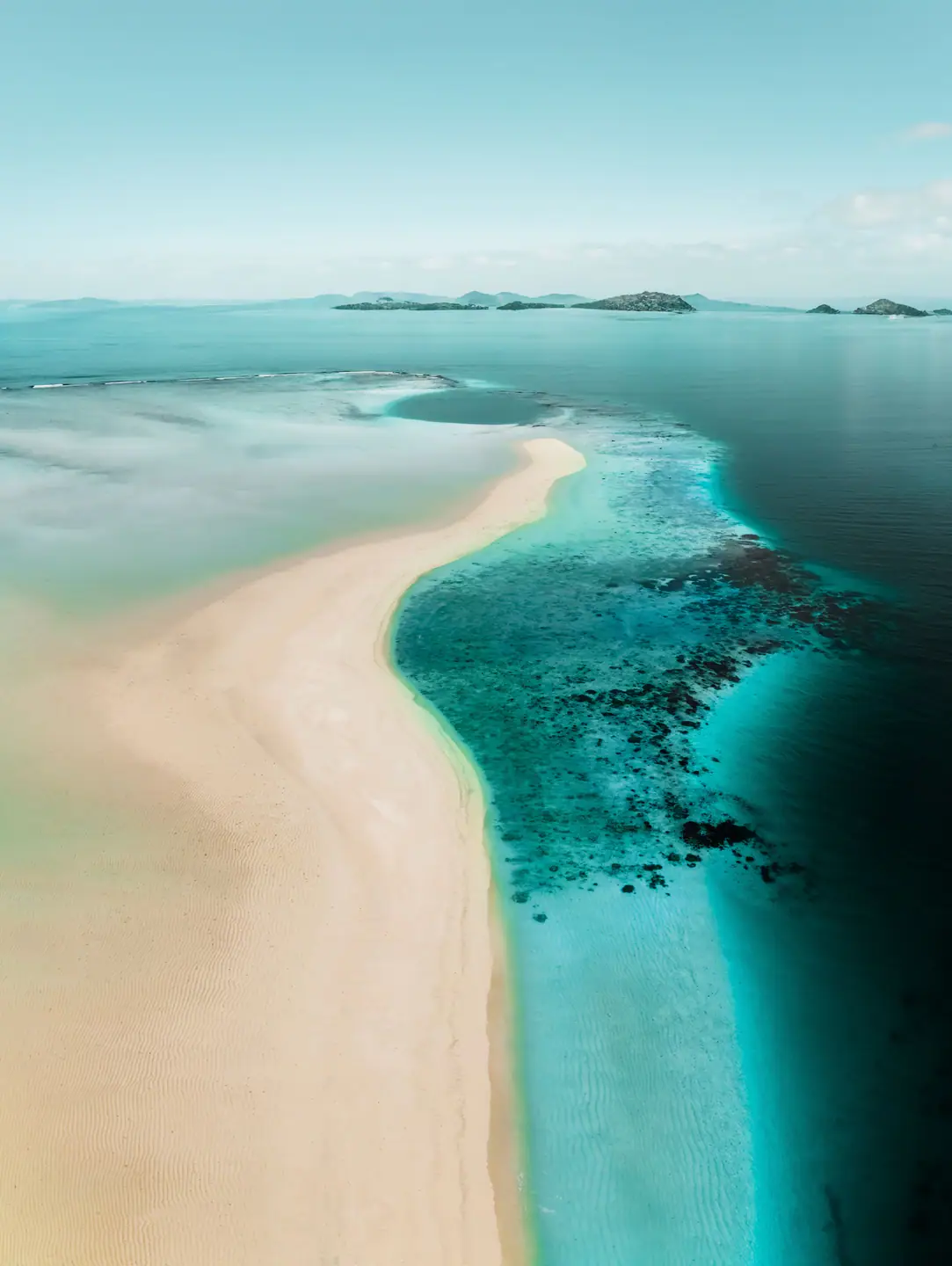 Aerial view of pristine Indonesian island perfect for private yacht adventure