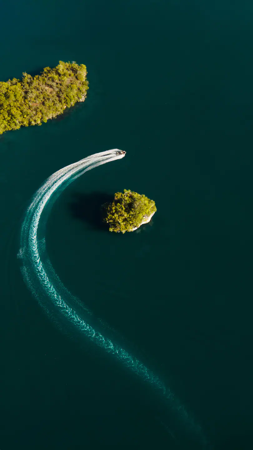 Tender boat cruising between karst islands Raja Ampat