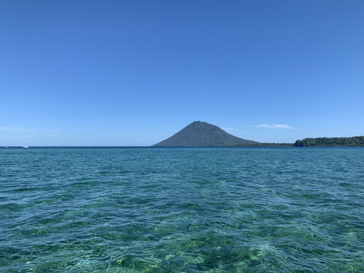 Bunaken marine park turquoise sea and volcanic mountain Sulawesi Indonesia